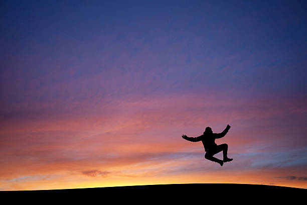 heel clicking man in sunset stock photo