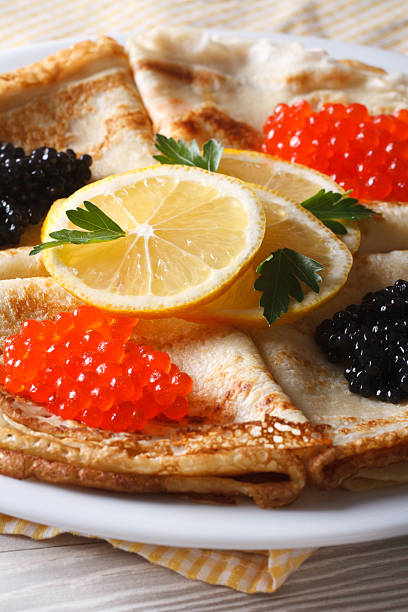 istock Crepes with red and black caviar close-up, vertical 480178688