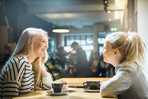 istock Happy young women looking at each other in cafe 480179462