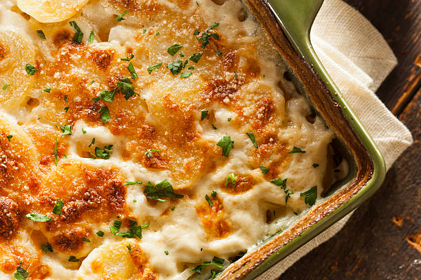 Homemade Cheesey Scalloped Potatoes Homemade Cheesey Scalloped Potatoes with Parsley Flakes casserole stock pictures, royalty-free photos & images