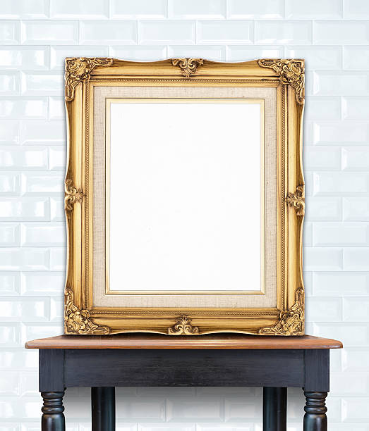 istock Blank vintage golden photo frame lean at ceramic tile wall 480187188