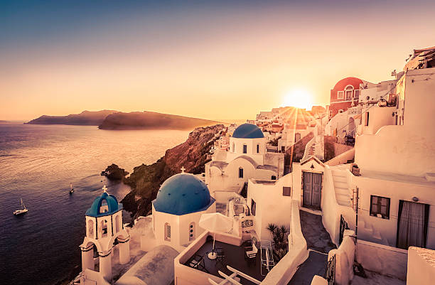 istock Sunset over blue dome churches of Santorini 480187194