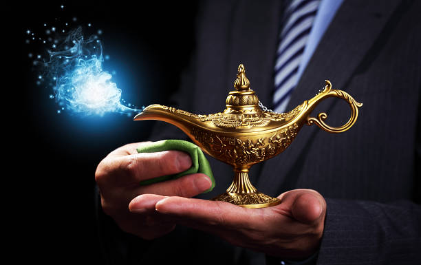 Rubbing magic Aladdins genie lamp Businessman holding and rubbing a magic Aladdins genie lamp concept for business aspirations, hope and wishes magic lamp photos stock pictures, royalty-free photos & images