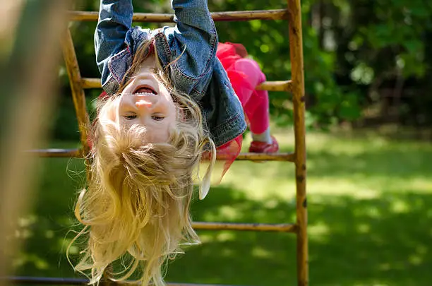 beautiful blond girl with long hair playing in playground