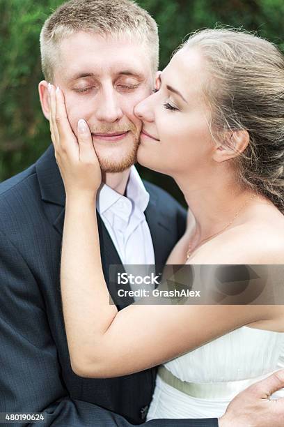 Bride And Groom Pressed Cheeks Stock Photo - Download Image Now - 2015, Adult, Adults Only