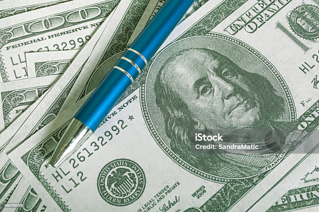 Dollar bill and pen Close up pen on USA dollar bank notes 2015 Stock Photo