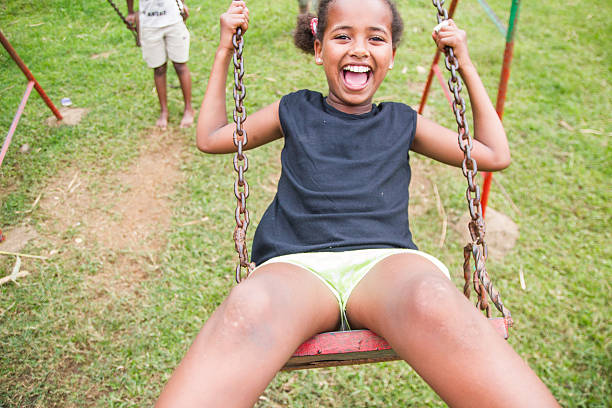 istock Young ethiopian girl swinging on a swing 480190786