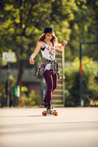 istock Cool young woman longboard skating at the park. 480191274
