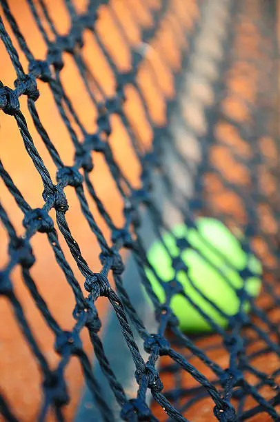 Tennis ball in a tennis clay court (Focus on net)
