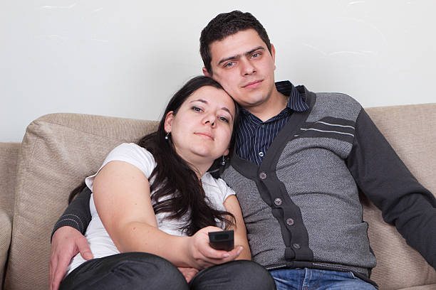 istock Young couple watching TV at home 480193169