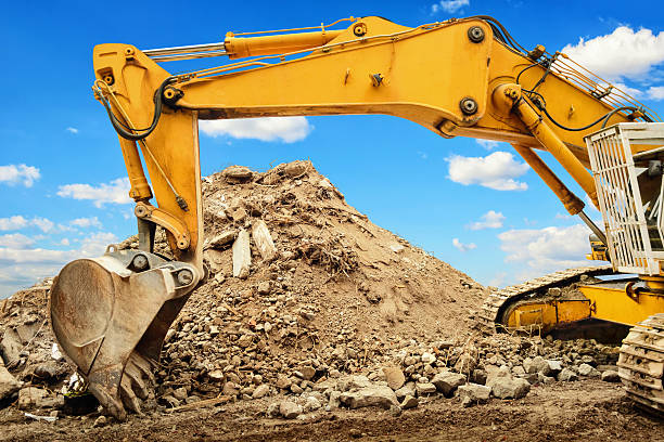 istock Excavator and heap of dirt with blue sky 480195112