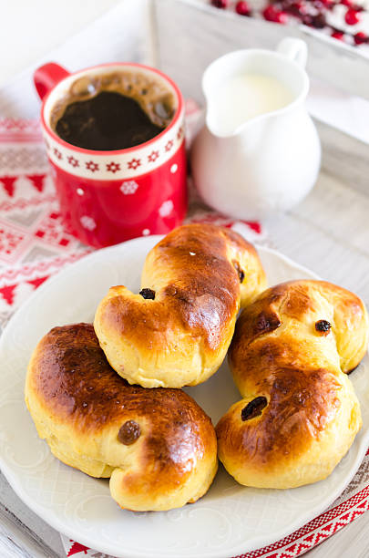 Traditional swedish saffron sweet buns with cup of coffee