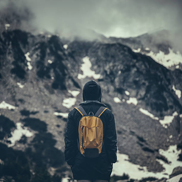 istock Traveler with backpack walking in a misty mountains 480195576