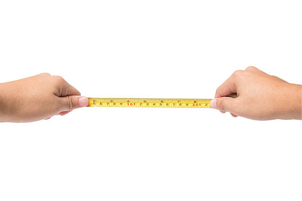 istock Hand holding tape cartridge meter isolated on white 480196126