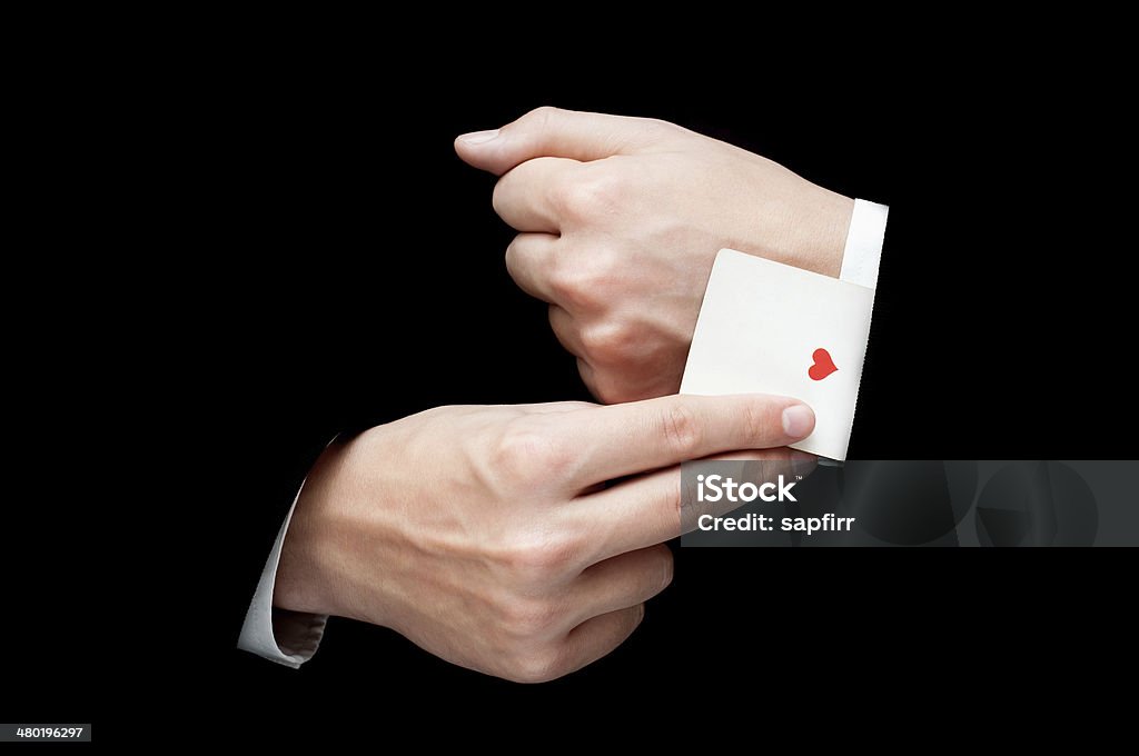 Ace Card hidden under sleeve man with ace card hidden under sleeve isolated on blackac Magician Stock Photo
