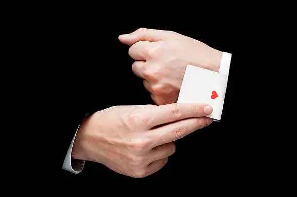 man with ace card hidden under sleeve isolated on blackac