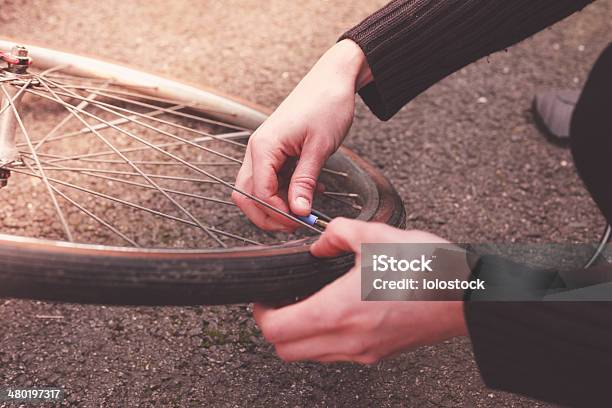 Woman Fixing Her Bike Stock Photo - Download Image Now - Activity, Adult, Adults Only