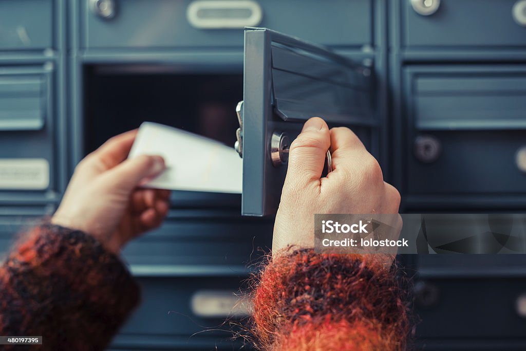 Checking for mail Closeup on a woman's hand as she is getting her post out of her letterbox Mailbox Stock Photo Checking for mail Closeup on a woman's hand as she is getting her post out of her letterbox Mailbox Stock Photo