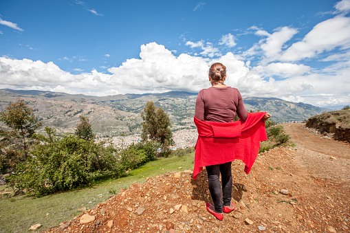 Mature hispanic woman rear view in the Andes above Huaraz