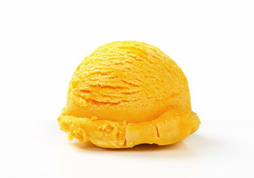 Scoop of yellow ice cream on white background