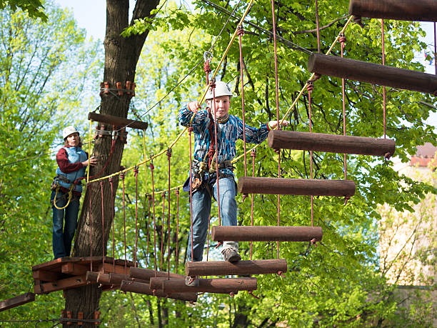 istock Little boy  with a safety carbine goes on a rope 480204430