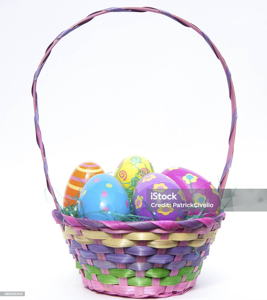 Easter Basket filled with colorful plastic decorative Easter eggs Enjoy Easter with this colorful basket of plastic decorative Easter eggs in green grass which are decorated with flowers, dots, swirls and stripes. Eggs come in blue, purple, pink, yellow and orange colors inside a vintage weaved Easter basket. Easter Basket Stock Photo