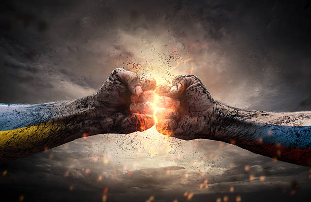 Conflict Close up of two fists hitting each other over dramatic sky war stock pictures, royalty-free photos & images