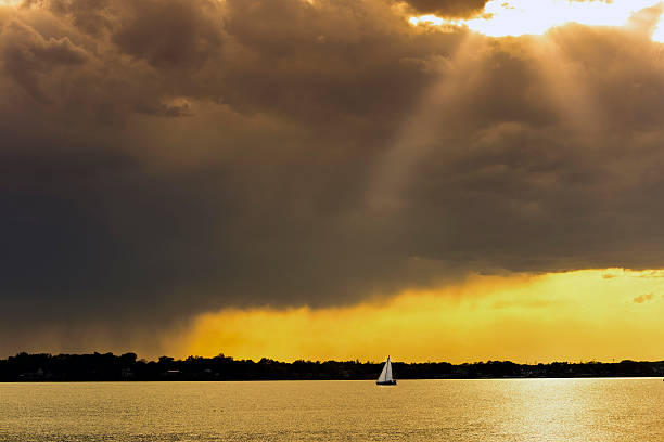 Homeward Bound Sailboat at sunset on the Chesapeake Bay with a stormy sky homeward stock pictures, royalty-free photos & images