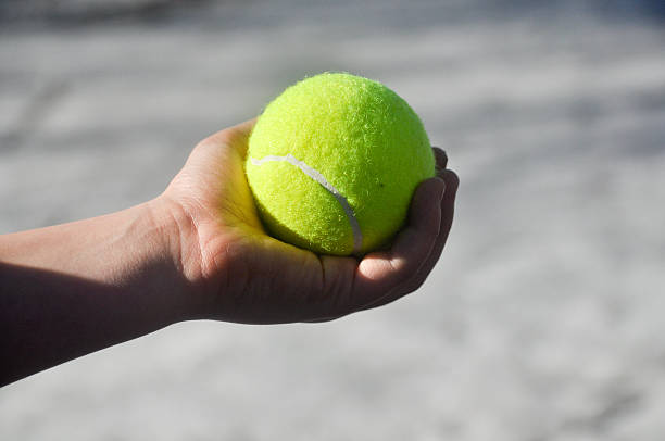 istock Tennis ball in the children's hands. 480215709