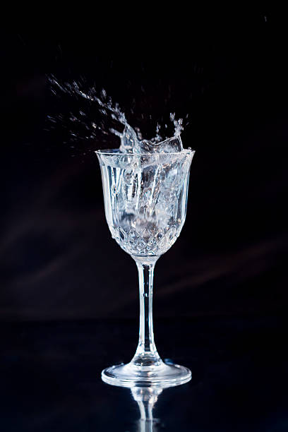 istock Crystal Wine Glass with Splashing Liquid spilling out of it 480215711
