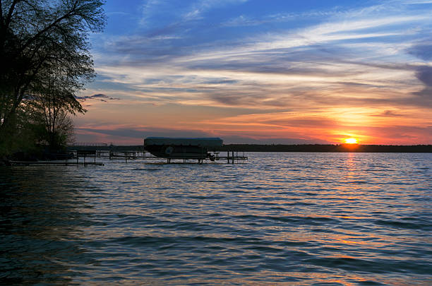 coucher de soleil sur le lac leech avec bateau en arrière-plan - leech photos et images de collection