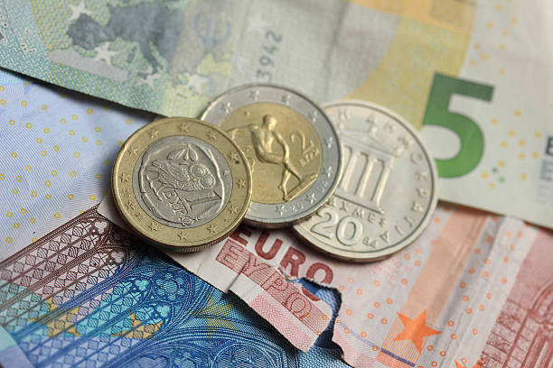 istock torn euro note and vintage greek coins 480216568