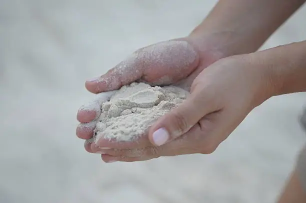 Fine sand on hands
