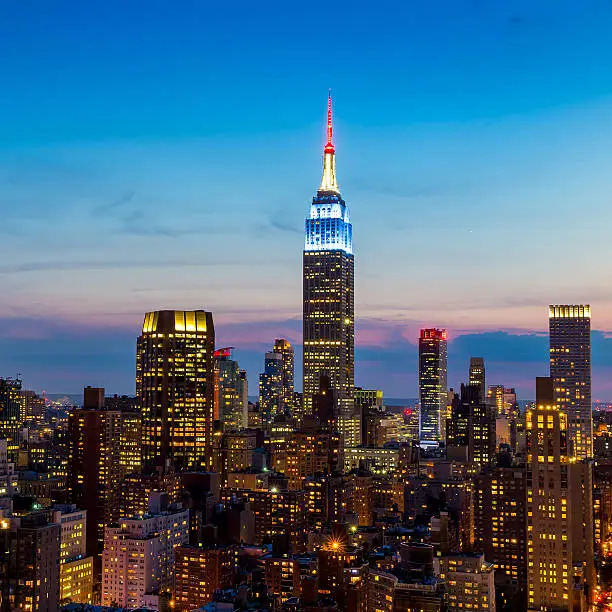 Photo of New York City skyline with urban skyscrapers at sunset.