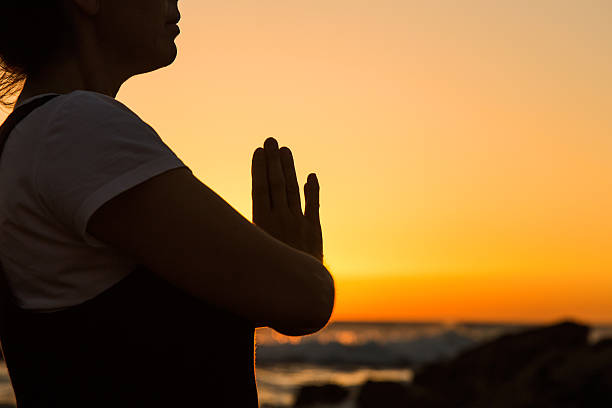 istock Silhouette young woman practicing yoga on the beach at sunset. 480224672