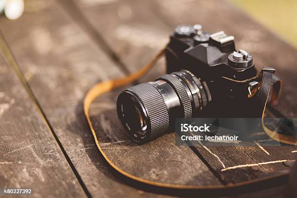 Analog Film Camera On The Table Stock Photo - Download Image Now - Camera - Photographic Equipment, Retro Style, Old-fashioned