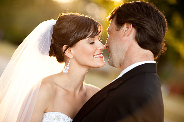 istock Bride and Groom Leaning in for a Kiss Outside 480231076