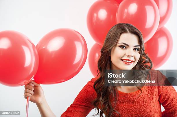 Pretty Young Woman In Red Dress Is Giving Present Stock Photo - Download Image Now - 2015, Adult, Affectionate