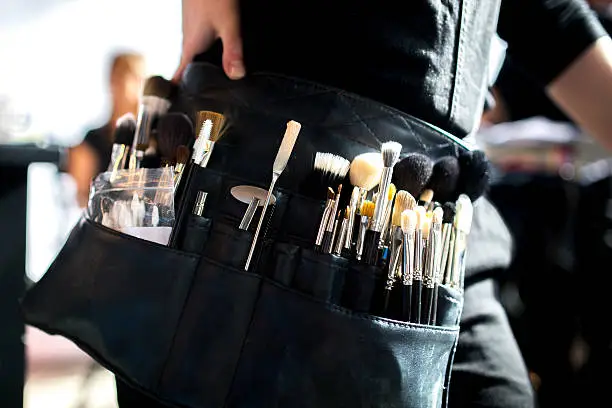 close-up of an make-up artist's belt with brushes and other accessories