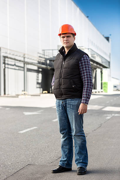 istock Full length portrait of engineer posing against big warehouse 480239824