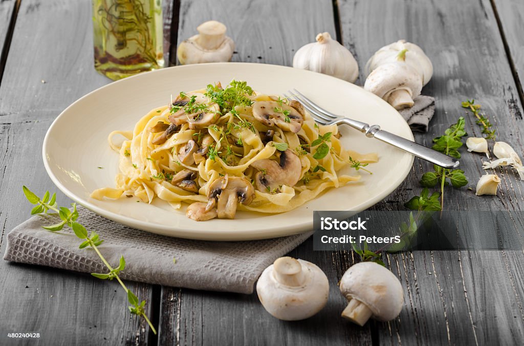 Fettuccine with garlic and mushrooms Fettuccine with garlic and mushrooms, olive oil and fresh herbs Porcini Mushroom Stock Photo