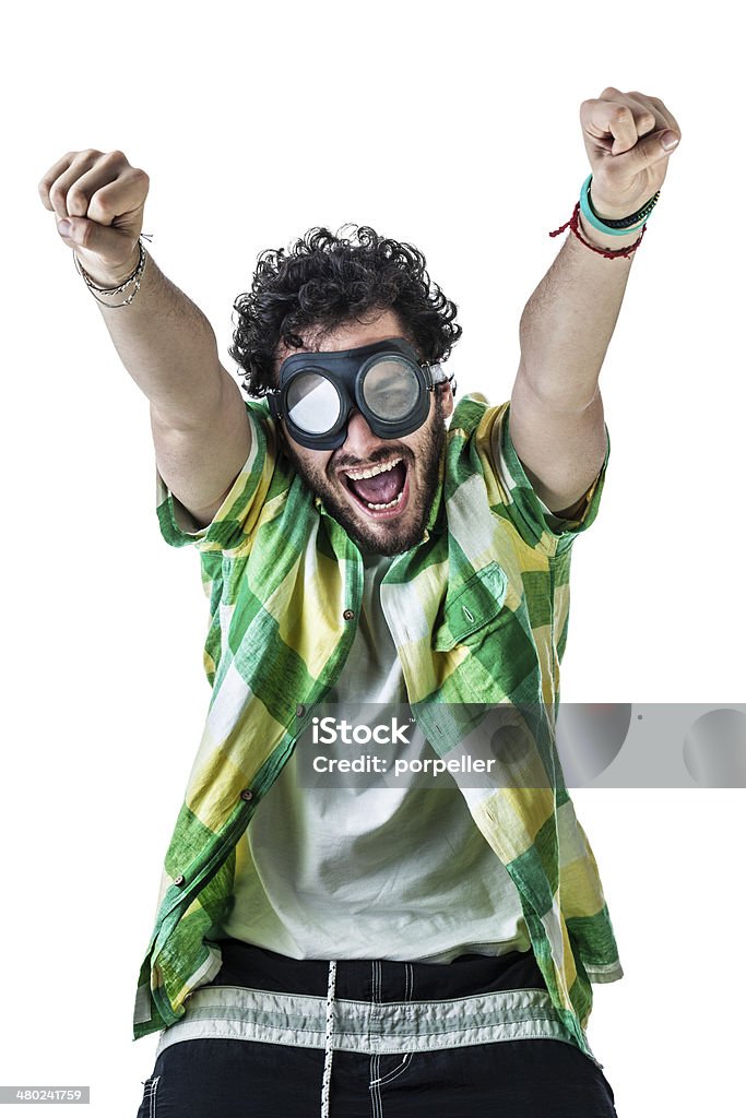 Exulting a guy wearing casual clothes and on old pair of goggles over a white bachground Flying Goggles Stock Photo