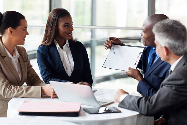 istock african businessman explaining sales graph to colleagues 480242697