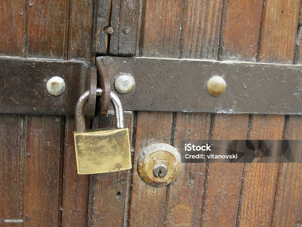 locked gate Old padlock on a wooden door Accessibility Stock Photo