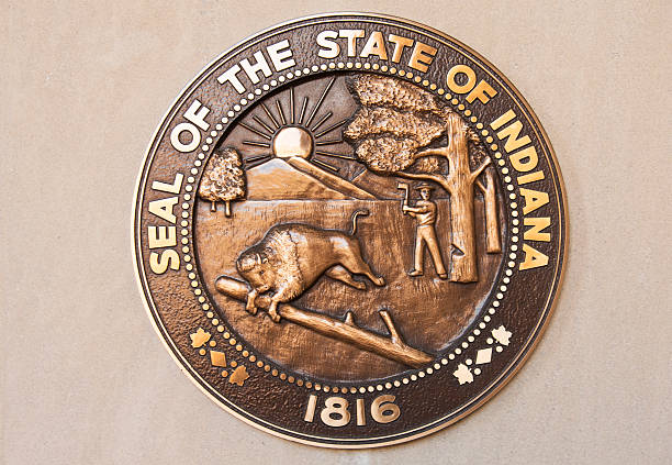 Seal of the State of Indiana The Seal of the State of Indiana in bronze cast hangs on a wall. Indiana will be celebrating its bicentennial in 2016. seal of the state of indiana stock pictures, royalty-free photos & images