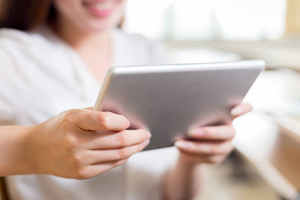 istock Asian beautiful female student study with tablet in classroom 480245494