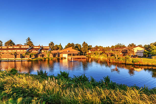 istock Townhouses by a pond at sunset 480245664