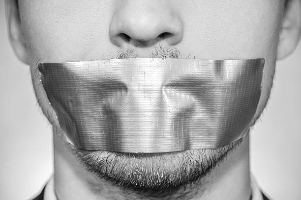 Man with sellotape Photo of a young man with sellotape covering his mouth closed mouth stock pictures, royalty-free photos & images