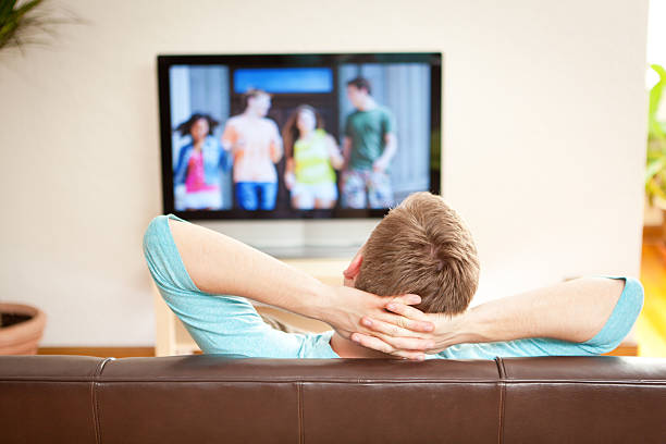 istock Young Man Watching Streaming Movie on TV Television 480247078