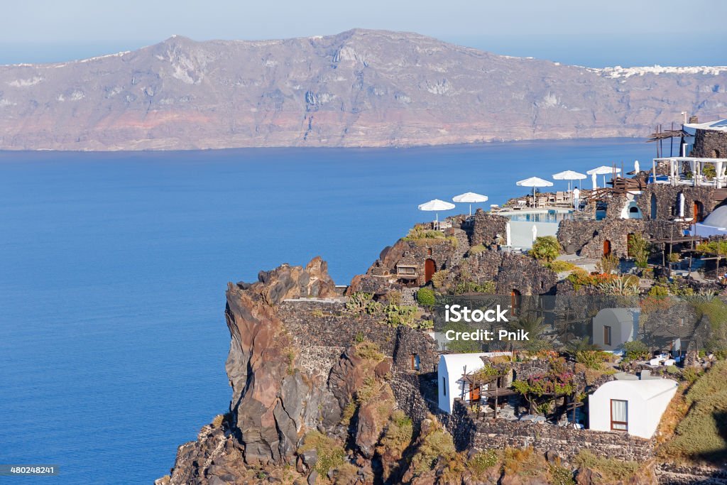 Tables and chairs on a balcony at Santorini, Greece Tables and chairs ready for customers on a balcony at Santorini, Greece Bar - Drink Establishment Stock Photo